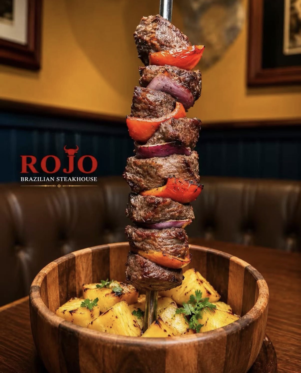 Grilled picanha skewer with peppers over grilled pineapple at ROJO